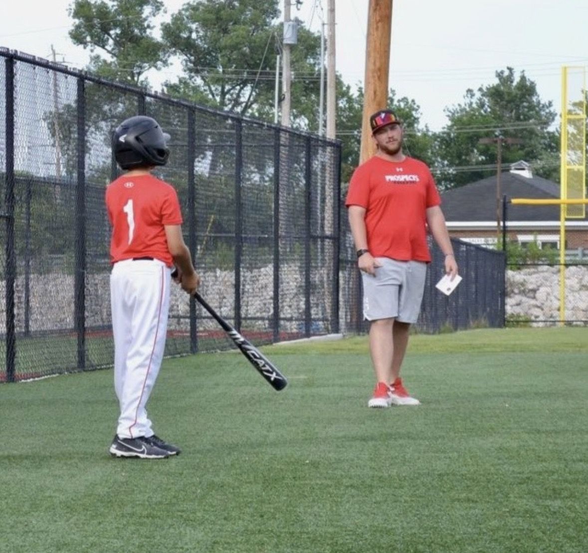 A Southside Prospects coach working with a hitter at practice