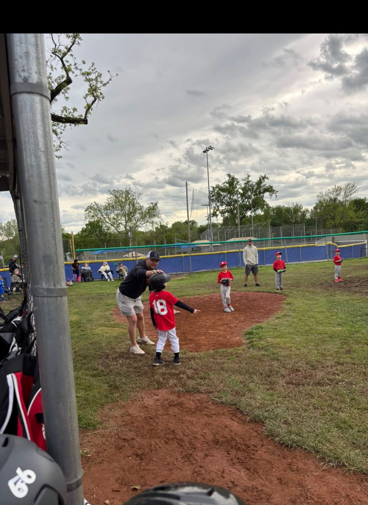 A Southside Prospects coach helping a young player on the field